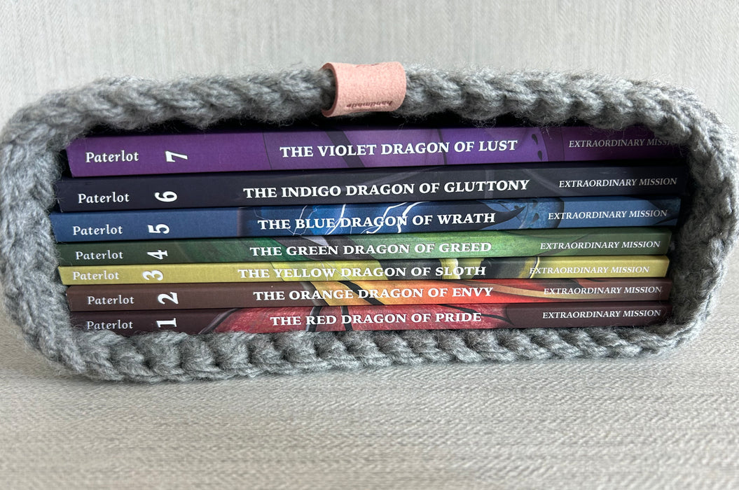 Set of books titled Seven Deadly Dragons book series in a woven bible journal cover on a light background