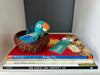 Brave on the Inside WonderBundle™—a picture book trio from the Character in Action Collection featuring Enemy Pie, Brave Irene, and The Thing Lou Couldn’t Do, displayed with a blue felted parrot in a brown nest and a Faith virtue bookmark.