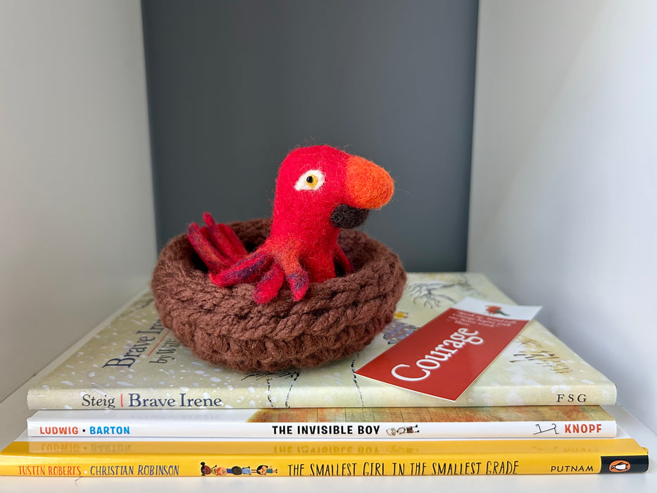 The Courage to Include & Persevere WonderBundle™—a virtue-rich picture book set from the Courage Collection, featuring Brave Irene, The Invisible Boy, and The Smallest Girl in the Smallest Grade, displayed with a red felted parrot and book companion tools.