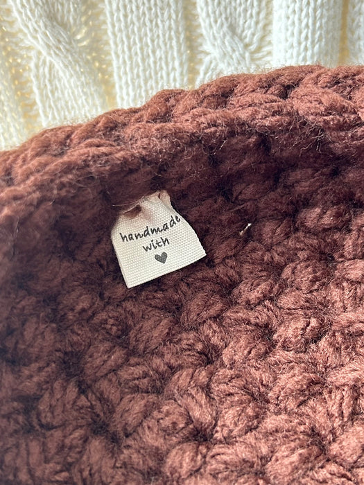 Close-up showing Verity Wells tag stitched into handmade Formation Nest.