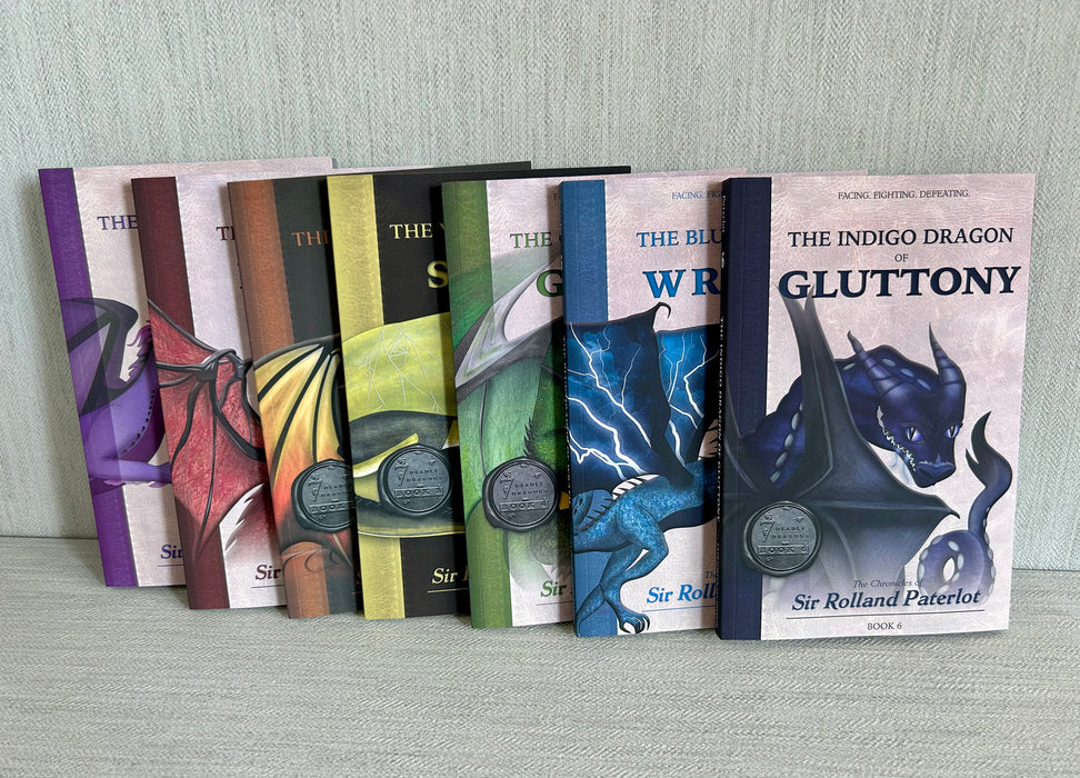 Seven Deadly Dragons virtue book set on gray textured background.