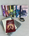 Seven Deadly Dragons virtue book set with prayer card, WonderGuide™, and ‘Pray to Slay’ bracelet on gray textured background.