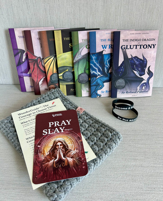 Seven Deadly Dragons virtue book set with prayer card, WonderGuide™, and ‘Pray to Slay’ bracelet on gray textured background.