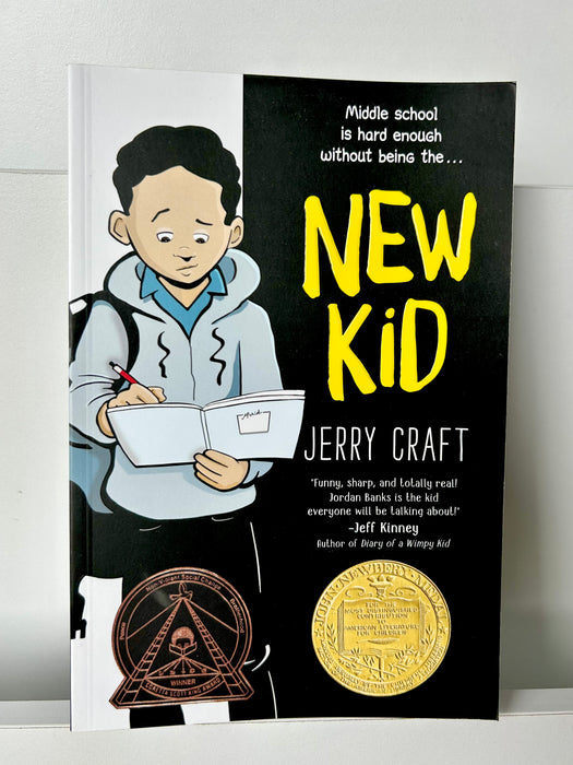 Cover of “New Kid” by Jerry Craft – a middle grade graphic novel featuring a cartoon boy with a sketchbook and backpack. Newbery Medal winner exploring identity, race, and belonging.