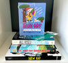 Stack of three middle-grade books—New Kid, The War That Saved My Life, and All Rise for the Honorable Perry T. Cook—topped with a boxed set of Truth Cards and a teal bookmark on a white shelf.