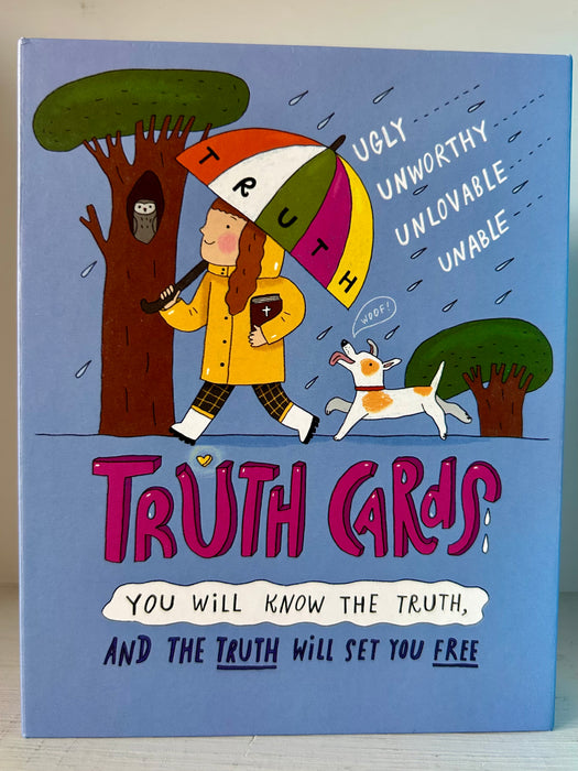 Cover of Truth Cards box set featuring a girl with a rainbow ‘TRUTH’ umbrella and a dog, walking past trees. Words like ‘ugly,’ ‘unworthy,’ ‘unlovable,’ and ‘unable’ appear as raindrops being deflected. Subtitle reads: ‘You will know the truth, and the truth will set you free.